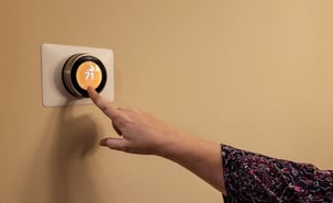 hand-adjusting-smart-thermostat